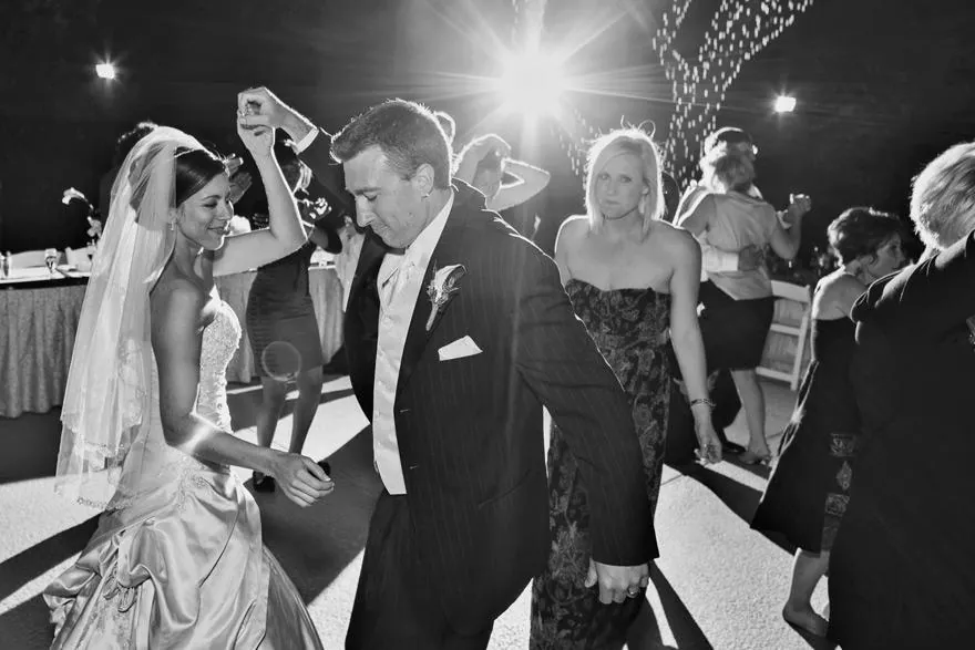 Couple dancing among guests at a black-tie reception